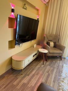 a living room with a large television and a couch at الشيخ زايد in Sheikh Zayed