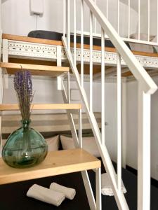 a glass vase sitting on a table next to a staircase at Casa Lina in Ostuni
