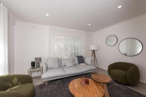 a living room with a couch and two chairs and a table at Elegant 2-bedroom House in Prahran w Parking! in Melbourne