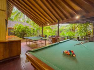 a pool table in a room with two tables at Sanctuary Rarotonga on the Beach (Adults Only) in Rarotonga