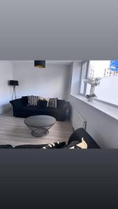 a living room with a couch and a table at 3 Bedroom House Near City Centre Glasgow Sleeps 7 in Glasgow