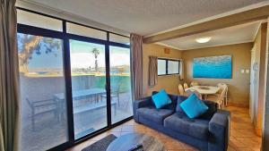 a living room with a couch and a view of the ocean at Riverview Holiday Apartment 13 - Kalbarri, WA in Kalbarri
