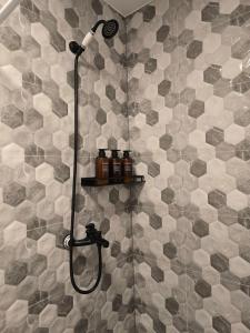 a shower with a shower head in a bathroom at ELDI House in Făgăraş +52 photos