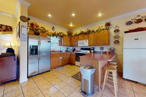 a kitchen with wooden cabinets and stainless steel appliances at Carebear 2 in Gatlinburg