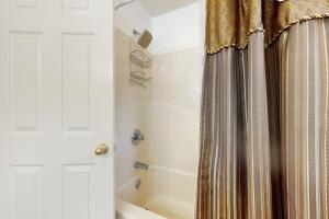 a bathroom with a shower curtain and a tub at Carebear 2 in Gatlinburg +28 photos