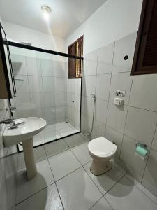 a bathroom with a toilet and a sink and a shower at Pousada Casarão 2030 in Natal