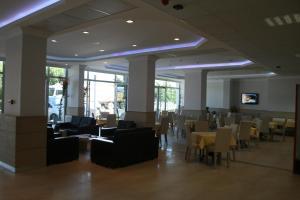 a dining room with tables and chairs in a building at Kale Palace Hotel in Gokceada Town