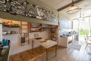 a kitchen with a counter and a sink in a room at MUTE Hostel Milfontes in Vila Nova de Milfontes