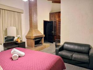a bedroom with a red bed and a fireplace at Love in the city in Guatemala