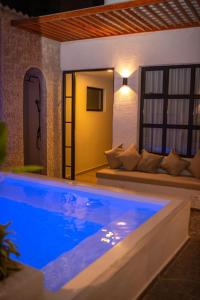 a swimming pool in a villa at night at NOVO Hotel Boutique in Ríohacha