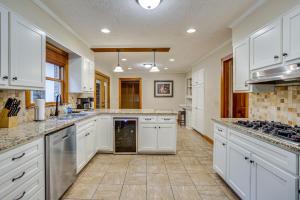 a large kitchen with white cabinets and appliances at Large Dahlonega Home, Ideal for Family Gatherings! in Dahlonega