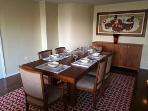 a dining room with a table with chairs and a tableablish at Apartamento Edificio Tuncahuan, 12 de octubre a 50mts Swissotel in Quito