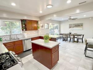 a large kitchen and dining room with a table at Orchard Villa Disneyland 5 Bedroom Pool Home Spa in Anaheim