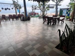 a patio with a table and chairs and the beach at Homestay view biển in Hoằng Lễ