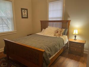 a bedroom with a large bed with a wooden headboard at Relaxing House at Downtown Chattanooga in Chattanooga