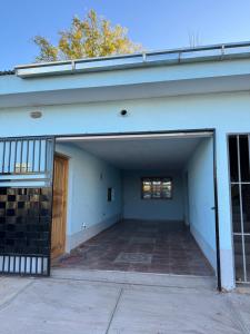an empty garage with a door and a building at Departamentos Malargue in Malargüe
