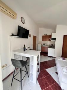 a white table and a chair in a room at Apartments with parking space Metajna, Pag - 208 in Metajna