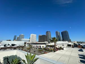 a view of a city with tall buildings and palm trees at The Century City Cozy 3 Bedroom Apartment with free parking! in Los Angeles