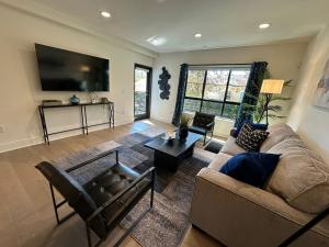 sala de estar con sofá y TV de pantalla plana en The Century City Cozy 3 Bedroom Apartment with free parking!, en Los Ángeles