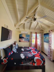 a bedroom with a bed with a comforter on it at The Surada Bay in Old Harbour