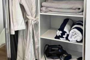 a walk in closet with towels and a purse at Ultimo in Sydney