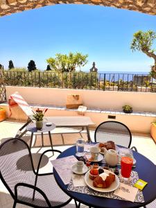 a table with food on top of a balcony at Le donne di Capri - Charming apartments in Capri in Capri
