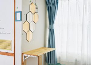 a desk in a room with a curtain at PEDAL TERRACE in Iida