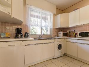 a kitchen with white cabinets and a washer and dryer at Gîte Saint-Brevin-les-Pins, 4 pièces, 4 personnes - FR-1-306-1049 in Saint-Brevin-les-Pins