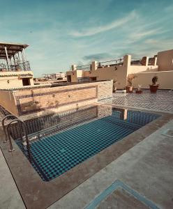 a swimming pool in front of a building at Riad Dar Tahri in Fez