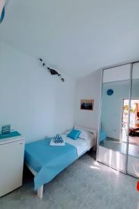 ein Schlafzimmer mit einem blauen Bett und einer Glaswand in der Unterkunft Holiday house with a parking space Cove Piskera, Solta - 21775 in Grohote