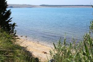 a view of a body of water with a beach at Apartments and rooms with parking space Povljana, Pag - 22707 in Povljana