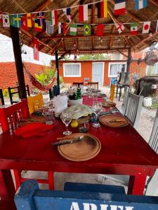 a red table with plates and wine glasses on it at Casa in Tristán Suárez