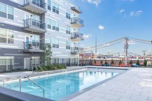 a swimming pool in front of a building at Modern Luxury Sanctuary Apt in DownTown Boston in Chelsea