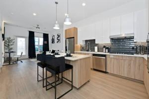 a large kitchen with a island in the middle at Modern Luxury Sanctuary Apt in DownTown Boston in Chelsea