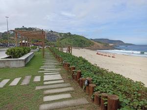 una escalera que conduce a una playa con playa en Refugio Piratininga térreo 102, en Niterói