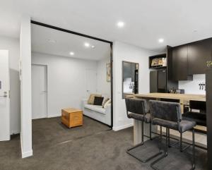 a living room with a bar and a couch at 2023 Stylish Central Apt+ Free Parking in Wellington