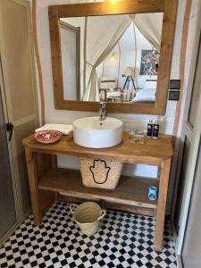 a bathroom with a sink and a mirror at Camp Sakura Desert Dream in Merzouga