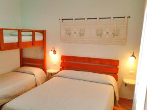 Ein Bett oder Betten in einem Zimmer der Unterkunft Nuraghe Bianco