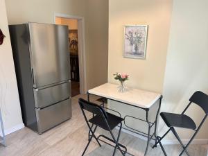 a kitchen with a table and a refrigerator at Keur Koura @The Ville in Saint Louis