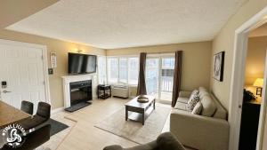 a living room with a couch and a fire place at Blue Mtn 1 Bedroom w Mountain View in Blue Mountains