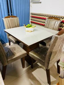 a table and chairs with a bowl of fruit on it at Apartamento Salvador/200m da praia. in Salvador