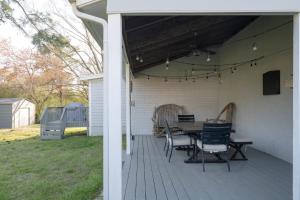 a patio with a table and chairs on a deck at 3Bed City Ranch near DTR in Raleigh