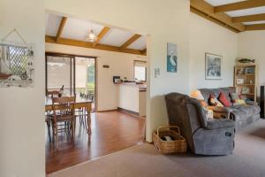 a living room with a couch and a table at Cave Street Retreat - 38 Cave Street Goolwa Beach - BYO Linen in Goolwa South