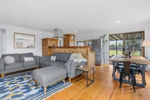 a living room with a couch and a table at Shanti - 4 Channon St Port Elliot BYO Linen in Port Elliot