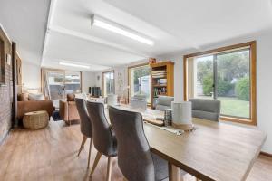 a living room with a dining room table and chairs at 58 Colman Rd Goolwa South - BYO Linen in Goolwa South