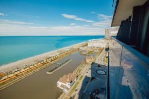 a view of the ocean from a balcony of a building at Panorama Sea Side Central Batumi in Batumi
