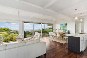 a living room with a white couch and a table at Encounter Bay Family Escape, Sea Views, Games Room & Walk to The Bluff in Encounter Bay