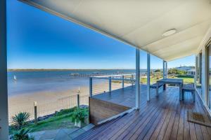 a view of the beach from the porch of a house at Beladura - 35 Goolwa Channel Drive Hindmarsh Island - Linen Included in Hindmarsh Island