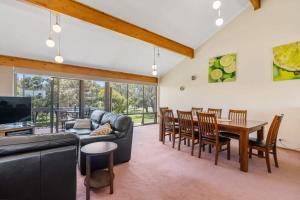 a living room with a couch and a table and chairs at 4 1 Harbour View Terrace BYO Linen in Victor Harbor