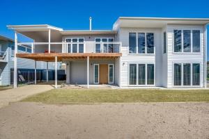 a large white house with a porch and a balcony at 5 Tabernacle Rd Encounter Bay- No Linen Included in Encounter Bay